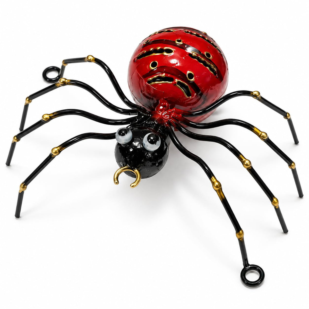 Rote dekorative Metallspinne mit schwarzen Beinen und goldfarbenen Details