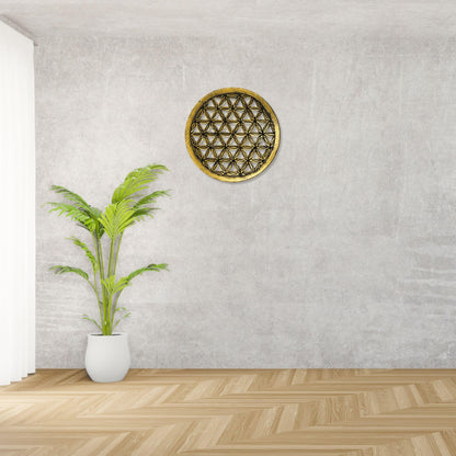 Im Wohnbereich: Goldfarbenes Blume-des-Lebens-Wandbild mit dunklem geometrischem Muster